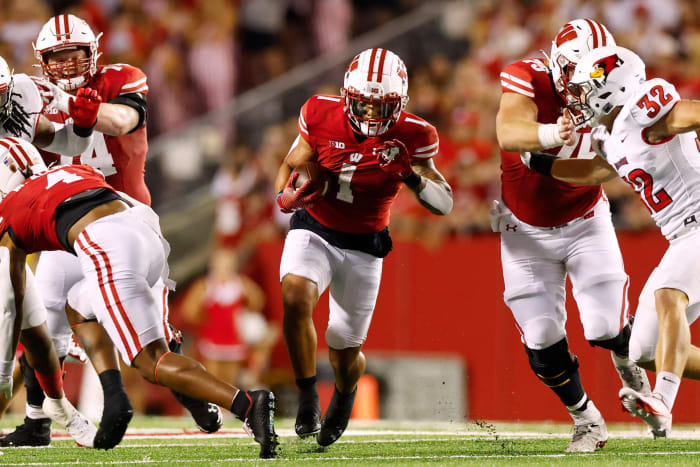 Wisconsin running back Chez Mellusi running through an open hole in the Illinois State defense